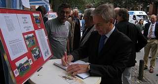 Herr Kayenburg trägt sich ins Gästebuch ein